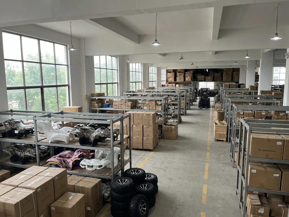 A factory worker welding a black ATV frame